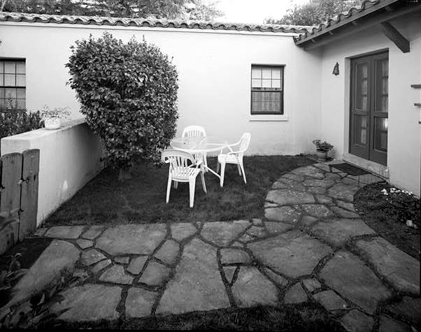 REAR COURTYARD, LOOKING TO BEDROOM HALL WINDOWS AND LIVING ROOM DOUBLE DOORS